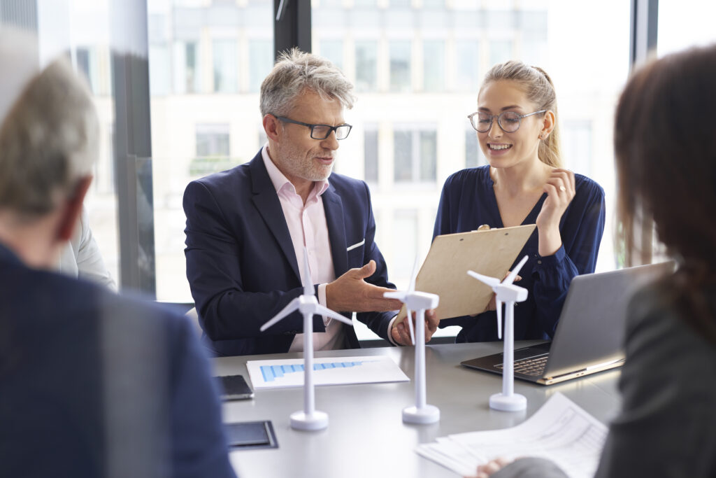 Business professionals in the energy sector discussing contracts in the boardroom.